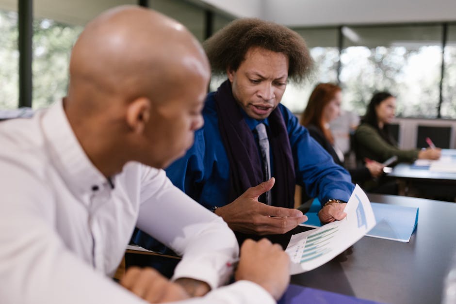 A team of professionals collaborating on business reports in an office setting.